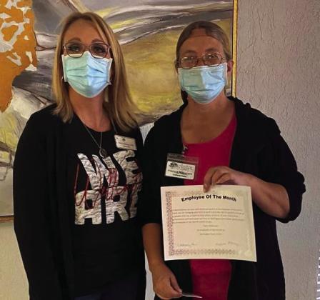 Dietary Manager Patty Wilkerson, right, accepts her Employee of the Month honor from Wellington Care Center Administrator Nikki Hathaway. Wilkerson received a Walmart gift card along with her certificate. “We are grateful for all your hard work,” Hathaway said.