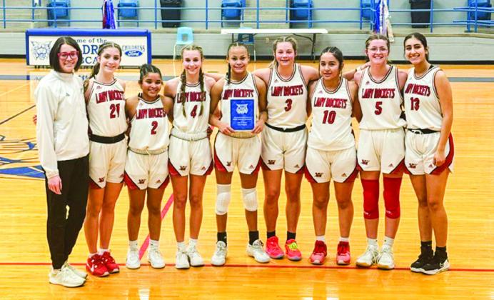 In the junior varsity division, the Wellington Lady Rockets secure the 4th Annual Childress Rotary Holiday Invitational Tournament Championship, taking a 39-26 win over Seymour. From left: Coach Courtney Head, Anna Henard, Demi Massey, Libby Chandler, Raelynn Castor, Maci Brewer, Hazel Estrada, Autumn Shatswell, Valerie Cruz. Wellington High School
