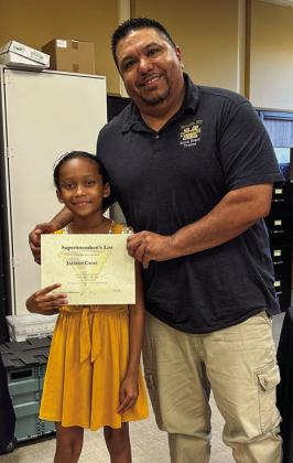 Third-grader Jaedah Casas is awarded by board members Joey Salinas.