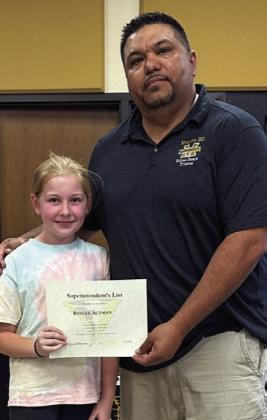 Fifth-grader Baylee Altman is awarded by board member Joey Salinas.