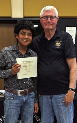 Seventh-grader Richard Garcia is awarded by Vice President Donnie Carroll.