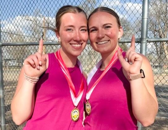 Girls’ doubles champions Bryn Phillips, left, and Oakley Folk display their first-place gold medal during the Wellington Tournament Tuesday, March 10.