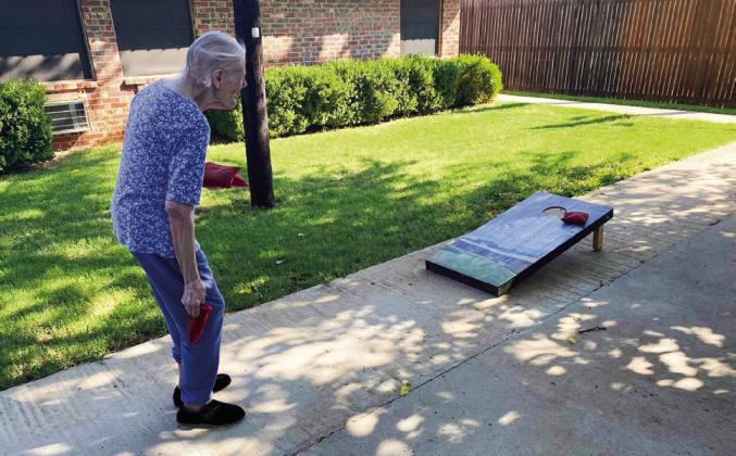 Courtesy Photos Wellington Care Center residents enjoy a recent early morning outing on the private patio, playing corn hole. Fingernail manicures followed. Organizers report the residents had a blast.
