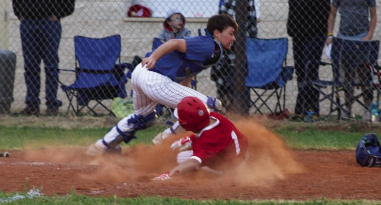 Wellington’s Major Brown (1) slides into home plate last Friday, March 24, scoring the game-winning run against the Nazareth Swifts in a 21-20 final. The Red River Sun/Shauna Salinas