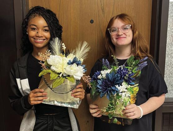 Memphis High School floral design students recently repurpose pumpkins, as well as gallon tin cans, using the items as alternative containers for fall centerpieces and door hangers. Photos Courtesy of Memphis ISD