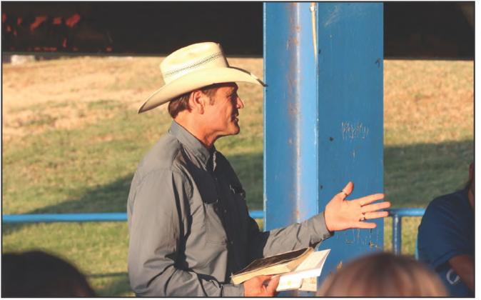 Stran Smith shares a moment with the Childress High School Class of 2024, including his son, Scout Smith, praying with the students.
