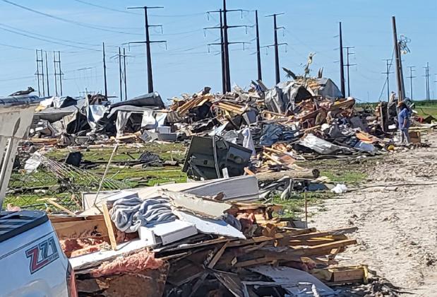 A woman surveys damage from the EF-3 tornado that hit Perryton June 15. The storm killed three people, injured at least 75 more and destroyed as many as 200 houses.
