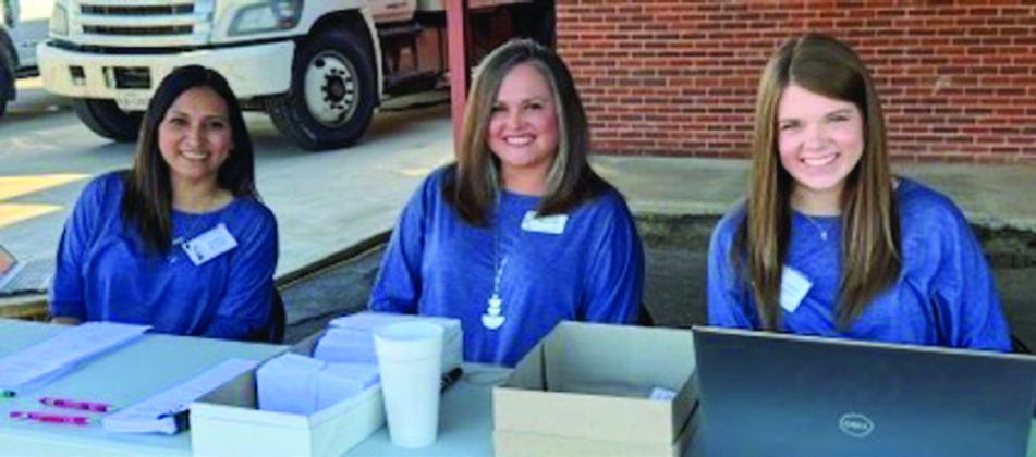 Greenbelt Electric Cooperative Accounts Receivable Clerk Maria Avalos, left, Chief Financial Officer Carly Ward and Accountant Cameron Warren register members during the recent drive-thru annual meeting. Guests entered from 9th St. and passed through the alley of Greenbelt Electric Cooperative’s headquarters at 706 10th St. in Wellington.