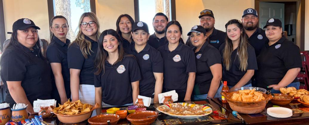 The Rodriguez family and Pueblo Viejo Mexican Restaurant staff serve delicious refreshments for its March 13 grand opening and ribbon cutting ceremony. Front, from left: Yvonne Rodriguez, owner Rebecca Rodriguez, Maria Avalos, Sandra Orozco, Grey Calderon, Isabel Pina. Back row, from left: Brenda Rodriguez, Vanessa Ruiz, Isabella Rodriguez, Leslie Rodriguez, Ramon Rodriguez, Isaiah Rodriguez, Isaac Rodriguez. The Red River Sun/Bev Odom