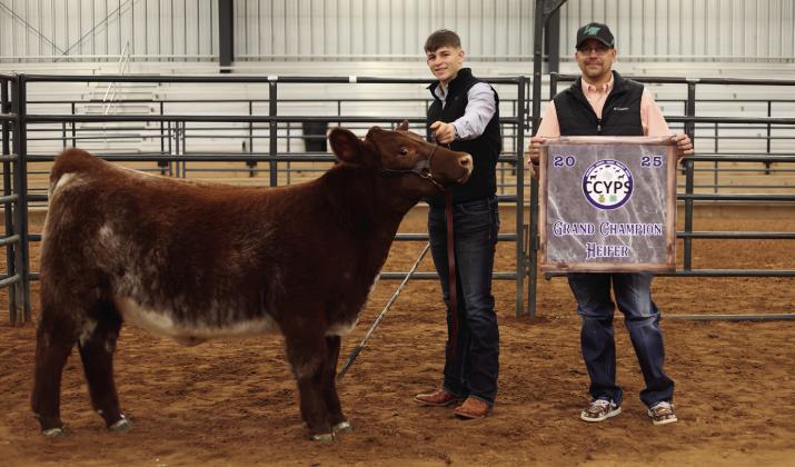 Drake Rabe exhibits the Grand Champion Heifer, purchased by Wellington State Bank, as well as the Reserve Grand Champion Heifer, purchased by First United Bank. Lane Photography