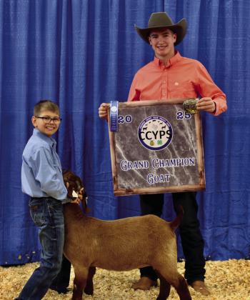 Wyatt Elliot exhibits the Grand Champion Goat, purchased by Rister Septic.