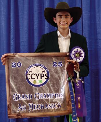 Tripp Tippett exhibits the Grand Champion Lamb, purchased by Kathy Fowler and Kevin Huddleston.