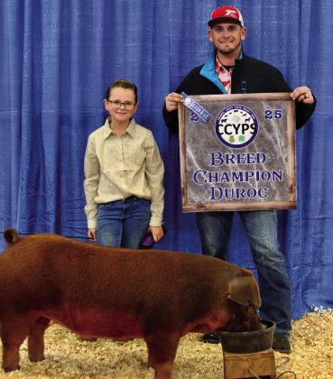 Cambri Willis exhibits the Duroc Breed Champion, purchased by Cherry Electric.