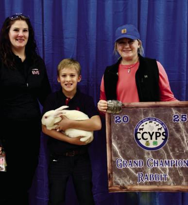 Addison Solis exhibits the Reserve Grand Champion Rabbit, purchased by Clayton Galyean.