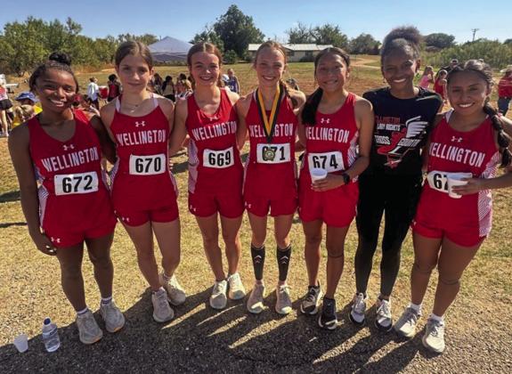 The Wellington Lady Rocket cross country team, including, from left, Aleah Lewis, Anna Henard, Addalyn English, Taytum Kane, Leslie Orozco, Angela Lewis and Sabrina Segovia, take their first team championship of the season at the Guthrie Rattlesnake Run Wednesday, Sept. 11. Courtesy Photo