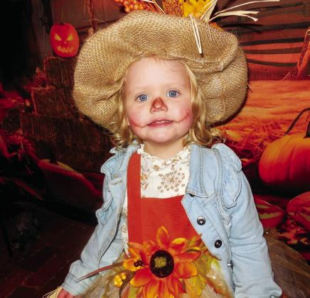 Madilynn Bradley, dressed as a scarecrow, takes the female child first-place prize of $50.