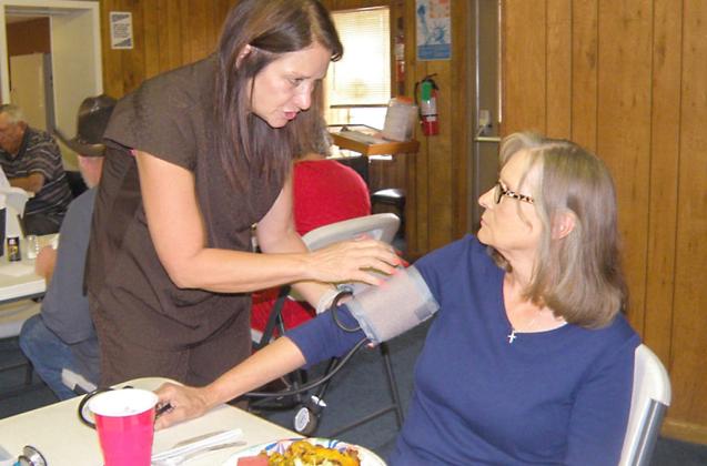Visiting nurse gives blood pressure checks