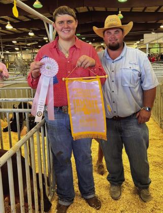 Wellington High School senior and Collingsworth County 4-H member Hunter Stark wins Reserve Breed Champion Duroc and Reserve Middle Weight Division Champion Cross at the 2022 Tri-State Fair Sunday, Sept. 18 in Amarillo. Collingsworth County AgriLife Extension Agent Kenny Patterson congratulates Stark. Courtesy Photos