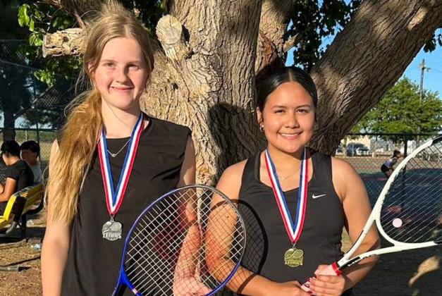 Memphis’ Alexa Rodriguez, right, takes first place in the girls’ singles Monday, May 11 at the Memphis Tennis Tournament. Hedley’s Abby Hood, left, took silver. MEMPHIS ISD