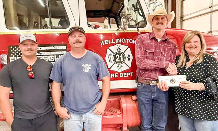 Wellington Volunteer Fire Department (WVFD) Chief Sawyer Sims accepts a $10,000 gift from The 100 Club of the Texas Panhandle Executive Director Suzanne Talley. From left: WVFD Treasurer Ethan Cummings, WVFD First Assistant Chief Matt Orr, Sims, Talley.
