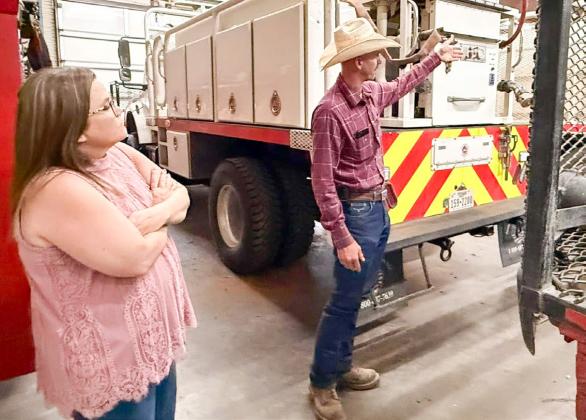 The 100 Club of the Texas Panhandle Program Support Specialist Julie Meier takes a tour of the station, guided by Wellington Volunteer Fire Department Chief Sawyer Sims.