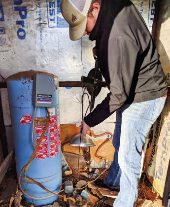 Mesquite Groundwater Conservation District staff measures water levels of an area well. Courtesy Photo