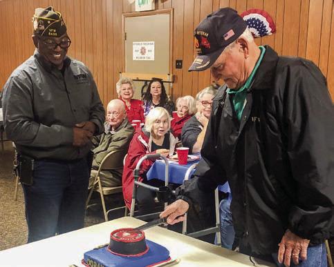 On Veterans Day, U.S. Marine Tony Stephens cuts the special cake to celebrate the 250th birthday of the military division. Stephens chronicled his experience in Vietnam in his book, “Shadow In My Mind: Ghosts of Viet Nam,” published in July 2009. The cutting of the cake took place following the brisket dinner at the Glynn Moore Veterans of Foreign Wars Post 6439. Post Commander Rodney Bishop, left, presented a tribute for the occasion. The Red River Sun/Bev Odom