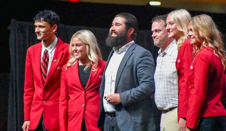 Childress High School Family, Career and Community Leaders of America (FCCLA) Adviser Jeffrey Collins, center, is awarded the Safe Roads Challenge Adviser Model of Excellence in Traffic Safety Award at the FCCLA National Leadership Conference Opening Session in Washington, D.C. CHILDRESS FCCLA