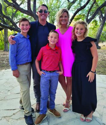 Luke and Amy Inman embrace their children, Lawson, 12, Jack, 9, and Ava Kate, 10, at a recent friends’ wedding in Austin. Amy received her cancer diagnosis in 2016 with her children 7, 5 and 3-years-old. She described this as probably being the hardest part, and she applauds her and Luke’s great parents, family and friends that continue to help them. Courtesy Photo