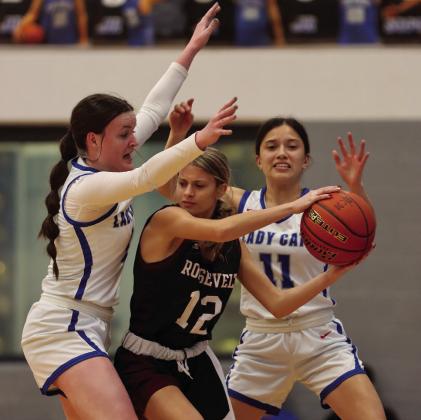 Childress’ Cameran Daniel and Clarissa Gamboa block Roosevelt’s Avery Putman during a 55-26 senior-night win Tuesday, Feb. 7. Photo by Childress High School Yearbook Staff