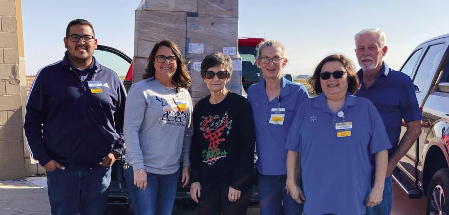 Walmart Supercenter donates clothing and shoes to Childress County Christmas Sharing (CCCS), a nonprofit organization which aids local families in need of assistance during the holiday season, giving them food, clothing and toys. Raymond McGee and Jimmy Smith picked up the items, which were accepted by CCCS Board Secretary and Treasurer Raenell Smith, center. Photo Courtesy of Childress County Christmas Sharing