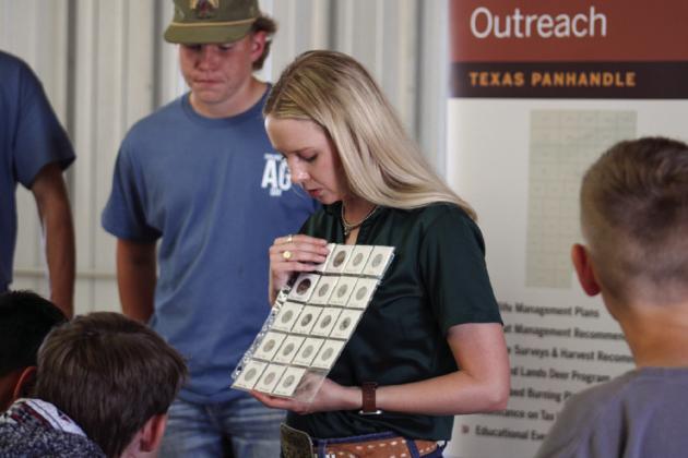 Texas Parks and Wildlife Department Wildlife Biologist Hailey Hawkins shows students seeds commonly ate by bobwhite quail during Childress County Ag Day Thursday, Oct. 24 at the Mashburn Event Center and Arena.
