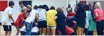 At the pep rally, members of four teams, chosen at random, search for matching shoes to win the game. Cheerleaders mixed up the shoes for the timed event as students raced against the clock.
