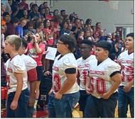 Firecrackers file into the Wellington High School Gymnasium for the “Sock It” River Road Wildcats pep rally.