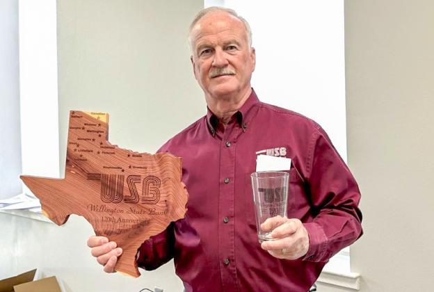 Wellington State Bank President and Chief Executive Officer (CEO) Richard Sims displays commemorative gifts given to stockholders in celebration of the bank’s 120th anniversary, including Texas-shaped cedar plaques engraved with each Wellington State Bank location and drinking glasses, each featuring the 120th anniversary mark. WELLINGTON STATE BANK