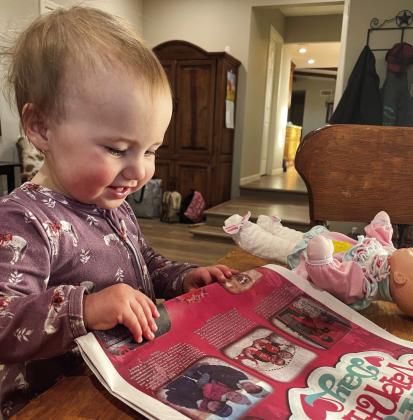One-year-old Anna Jewel Brown enjoys finding herself with older siblings Trey and Kaylee, plus other children, in the Valentine section of a recent issue of “The Red River Sun.” Brown is the granddaughter of The Red River Sun Associate Editor Bev Odom, of Wellington. Courtesy Photo