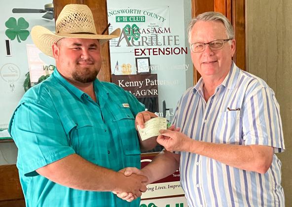 Collingsworth County Extension Agent Kenny Patterson accepts a $1,000 contribution from Wellington Lions Club, represented by Lion Neal Odom. The proceeds to Wellington Gun Club are for the benefit of the 4-H Shooting Sports Project youth activities. Courtesy Photo