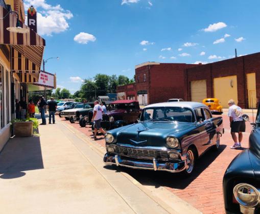Bob Owens greets car enthusiasts as they gather at the historic Wellington Ritz Theatre in July. The Red River Sun/Elizabeth Tanner