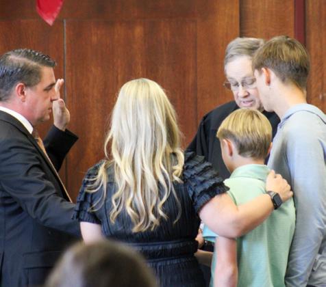 Joined by his family, including wife Lori Rabe and sons Max and Drake Rabe, Dale Rabe, Jr. is sworn into the 100th Judicial District Court by the Honorable Stuart Messer in October. The Red River Sun/Elizabeth Tanner