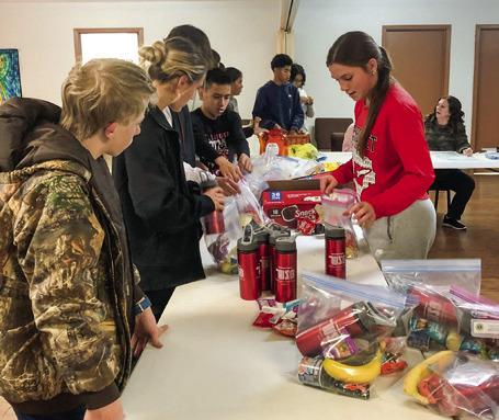 Students assist Wellington Lions Club with senior snack packs