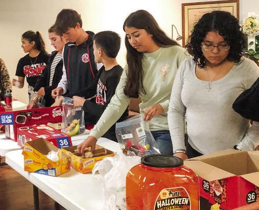 Students assist Wellington Lions Club with senior snack packs