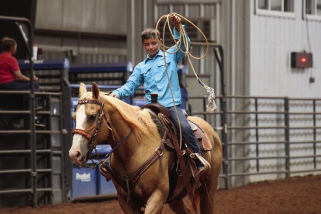 Quay Bruce, of Childress, wraps up competition in the 12-and-under breakaway roping during the STS Jr. Championship Summertide Saturday, Aug. 20.