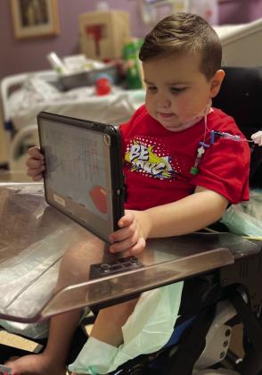 Only a few days after receiving his new kidney, five-yearold Clive William Downing plays on his iPad at the Dallas hospital. For photos of Clive’s Fearless Warrior factions, see page 8B. Courtesy Photo