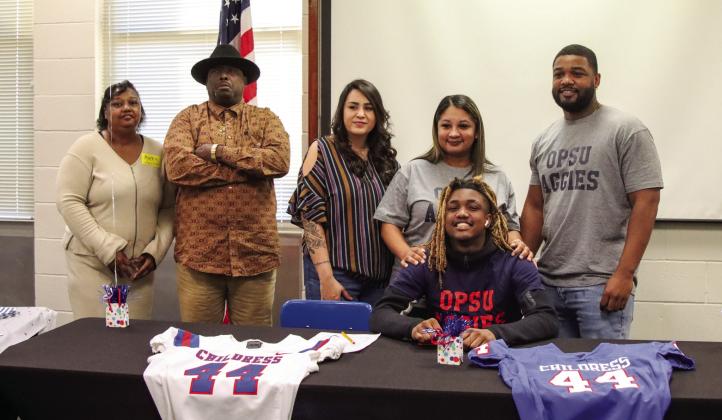 Childress’ Kobe Sims signs a National Letter of Intent to play football at the collegiate level at Oklahoma Panhandle State University, located in Goodwell, Okla., Monday, Feb. 3 in the Childress High School Media Center. Childress High School Yearbook Staff