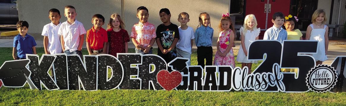 On their way to their kindergarten graduation, Kacy Cabbell’s Wellington Elementary School students admire the yardcard sign in their honor. From left: Jonah Akemon, Jayden Alvarado, Drake Barlow, Dallas Castor, Kenleigh Cummings, Yahir Estrada, Diego Gonzales, Andrew Hughs, Alias Jones, Brantley Kemp, Blake Lemons, Ezekiel Rivera, Evelyn Sanchez, Whitney Souder. Wellington Elementary Sparklers