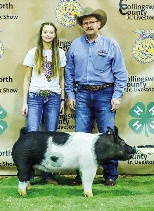 At the Saturday, Jan. 14 Collingsworth County Livestock Show Premium Sale, Maci Brewer displays her second-place class 1 cross swine with buyer Boedecker Flying Service, represented by Dale Dunlap. Molly Sims Photography