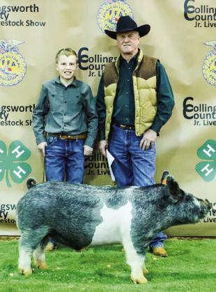 Miles Ouellette exhibits his second-place class 4 cross swine with buyer Wellington State Bank, represented by Richard Sims.