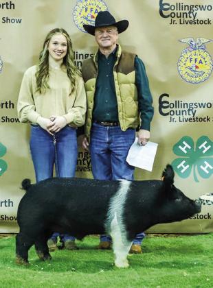 Kaitlin Bawcom displays her third-place class 3 Hampshire swine with buyer Wellington State Bank, represented by Richard Sims.