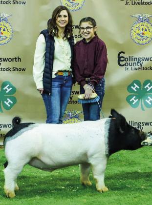 Brylnn Kemp shows her second-place class 2 cross swine with buyer Cattlemens Bank, represented by Danna Robinson.