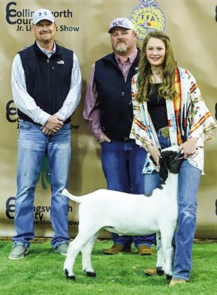 Ellie Thomas displays her third-place class 2 goat with buyer OTC Cattle, represented by Craig Ouellette and Jared Patterson.